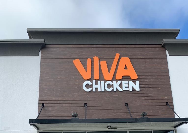 The exterior of a building features a sign that reads 